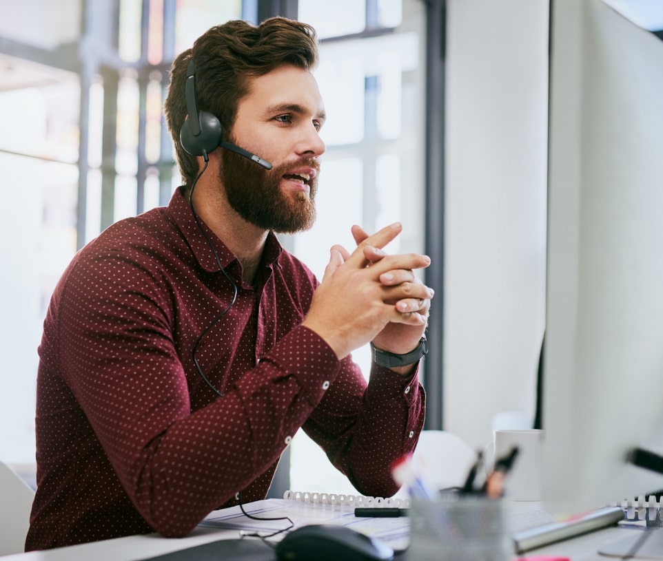 man with beard talking on headset