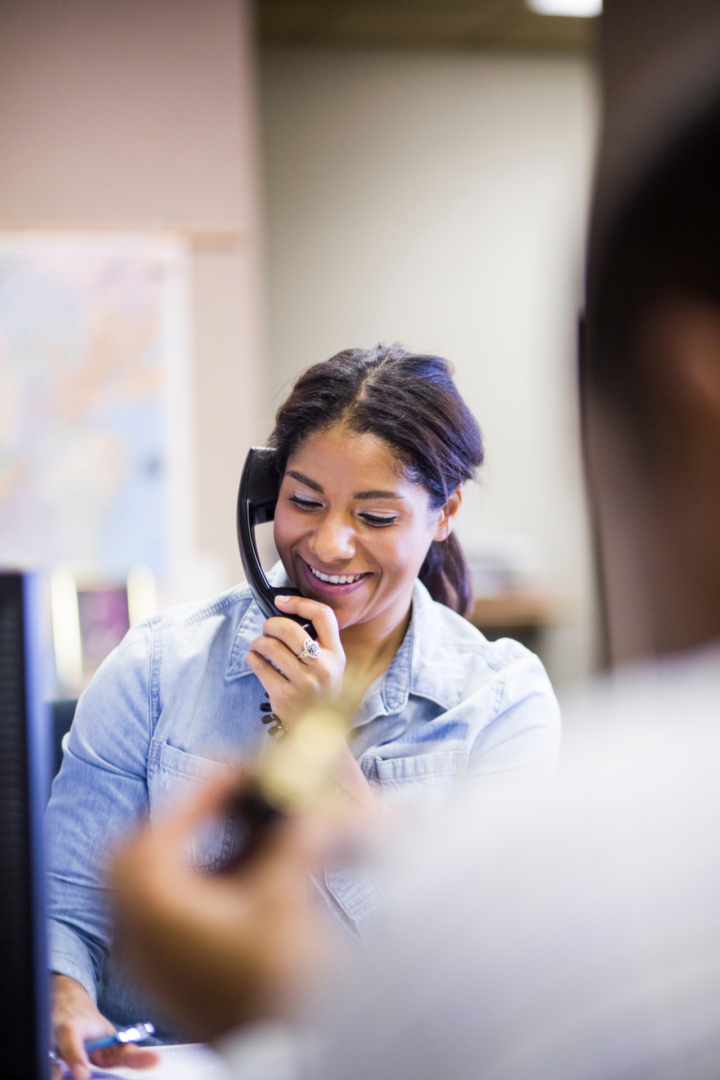 Female office worker on landline phone | Featured Image for the Caller Experience blog
